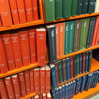 Image of brightly colored journals on crowded shelves